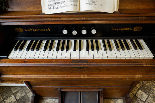 Piano keys on a vintage upright piano and wood grain of classic piano,Classical music instrument with polished wooden finish, education concept,concert promotion, copy space.