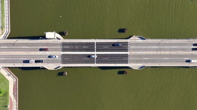 Aerial top down view of traffic moving over a bascule bridge in Bay city, Michigan.