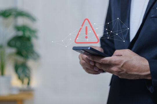 Business Professional Using Smartphone with Digital Warning Icon Overlay