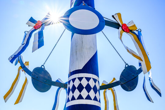 typical bavarian maypole in front of blue sky