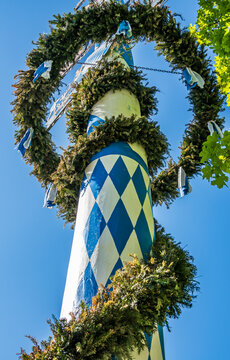 typical bavarian maypole in front of blue sky
