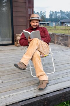 Peaceful moment of a relaxed man reading on a terrace in a rural setting