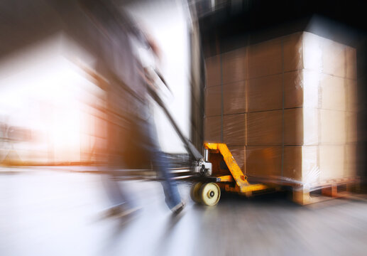 Motion Blurred of Workers Loading Shipment into The Truck. Forklift Loader. Bulk of Package Boxes Pallets. Distribution Storage Warehouse. Supply Chain, Supplies Shipping. Logistics Transportation.