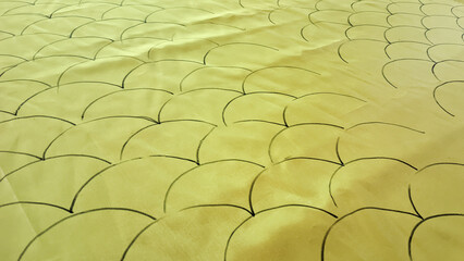 hand-drawn black scale-like pattern on bright yellow fabric. as wallpaper or graphic design © rio