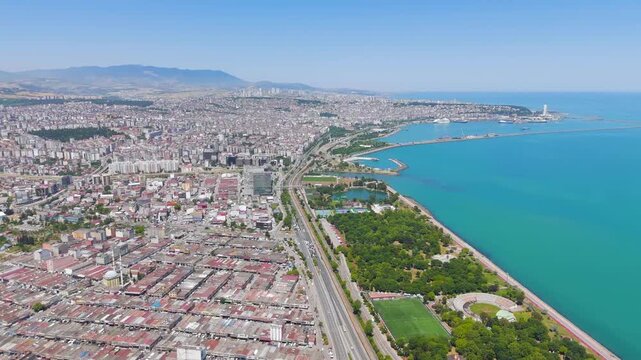 Samsun, Turkey. Panoramic aerial view over the Black Sea coastline, dense urban grid and coastal highway stretching toward the horizon under clear summer sky. Aerial View