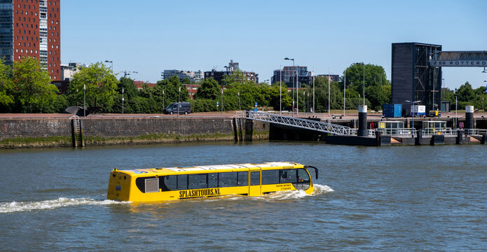 Yellow Splash Tours amphibious bus cruising on Nieuwe Maas by Rotterdam waterfront Netherlands