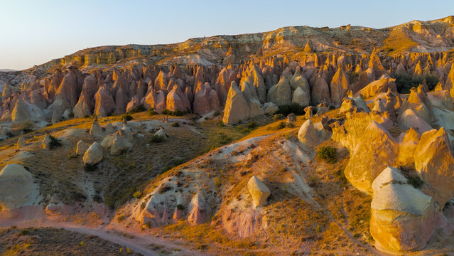 Goreme, Nevsehir, Turkey. Evening aerial perspective of Devrent Valley highlighting geological diversity and mineral color variations at dusk.. Aerial View