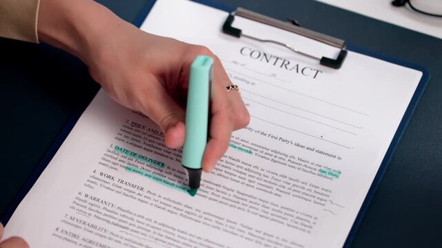 Lawyer Carefully Reviews Contract Terms With Highlighter