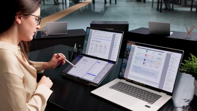 Office Manager Organizing Digital Documents On Dual Touchscreen Laptop