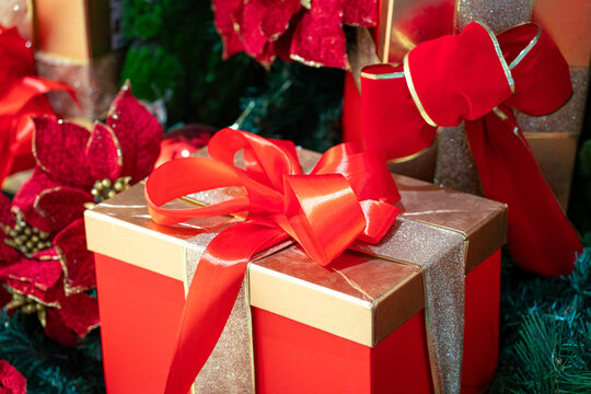 Christmas presents wrapped and tied with red ribbons. Holiday and festive concept.