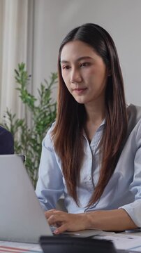 Young asian businesswoman working on a laptop