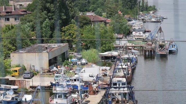 Fishing boats and trawlers docked at industrial river port