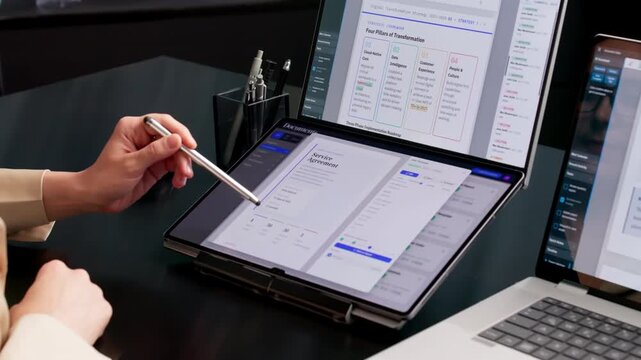 Office Manager Organizing Digital Documents On Dual Touchscreen Laptop