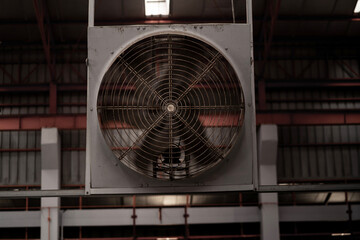 Fototapeta premium Industrial Ventilation Fan Installed Inside Modern Steel Manufacturing Factory for Workplace Air Circulation and Heat Management