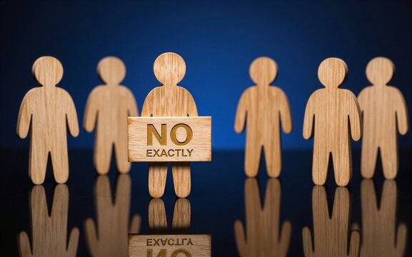 Wooden figures, one holding "NO EXACTLY," symbolizing nuanced rejection or hesitation.