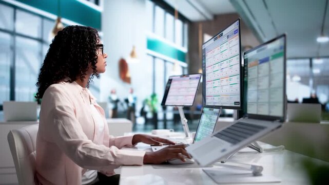 Business Analyst Reviewing Integrated ERP Software On Desktop