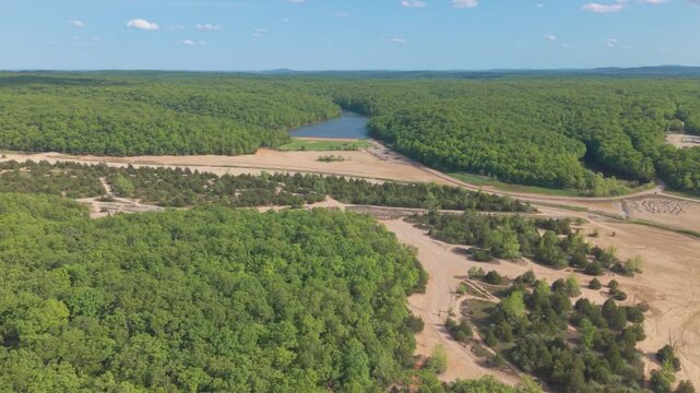 Aerial Drone View of Pim Lake and Off-Road Trails at St. Joe State Park
Description: A sweeping, high-angle aerial drone shot flying over the rugged landscape of St. Joe State Park in Park Hills, Miss