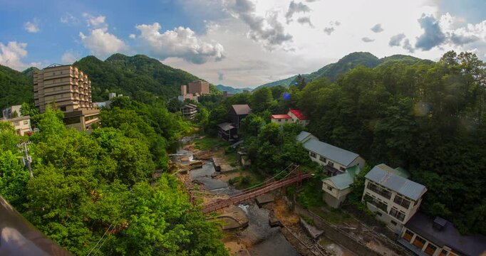 Jozankei Onsen Daytime Timelapse: Futami Suspension Bridge and Toyohira River Valley, Sapporo, Hokkaido, Japan - Wide Angle Shot