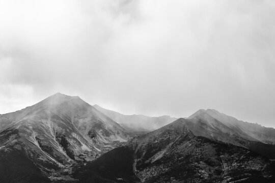 Dramatic black and white mountains with moody clouds