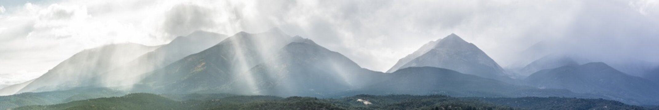 Dramatic light rays over a vast mountain range
