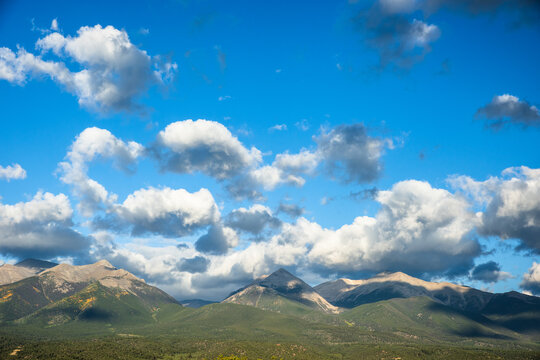 Cloud shadows move across a scenic mountain range