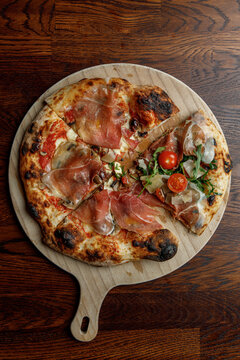 Freshly baked pizza with a slice of another pizza. Art.