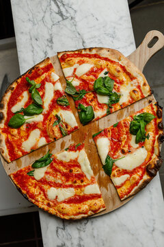 Freshly baked Margherita pizza from a pizzeria, isolated