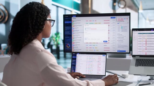 IT Support Specialist Carefully Manages Helpdesk Tickets Using Laptop