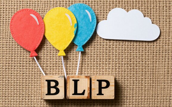 Colorful balloons float above wooden blocks spelling BLP on a textured background.
