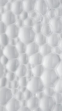 White Foam Bubbles Dissolving. Soft translucent bubbles gradually recede across a smooth white liquid surface. Ideal for clean abstract backgrounds.