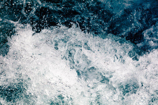 Ocean waves crash with white foam and deep blue water
