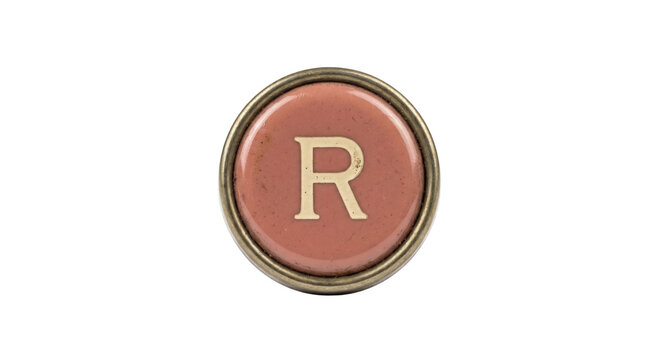 Vintage typewriter key with the letter R on a dusty pink background