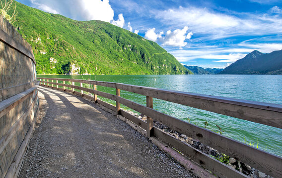 pedestrian bridge crossing along a nature reserve bordering biotope of Idro lake  in mountain, trento country Italy