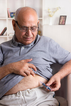 Old man giving himself insulin injection