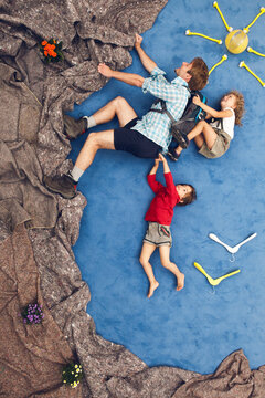 Father climbing with son and daughter in creative studio scene