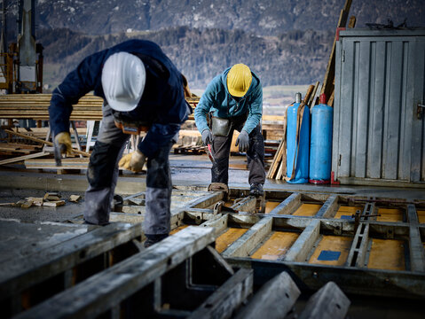 Construction workers working on plywood