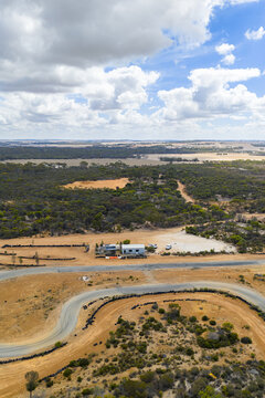 Aerial view of winding dirt road through rural landscape