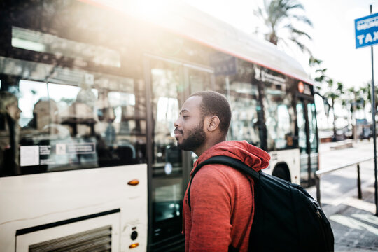 Young man in the city waiting for the bus