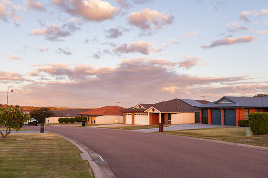 dusk sky over houses on suburban street in Australian town