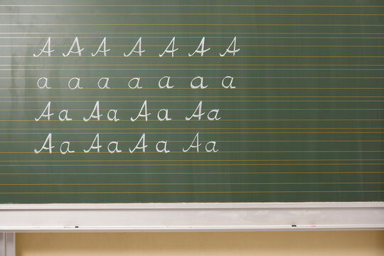 Variations of letter A at blackboard in classroom