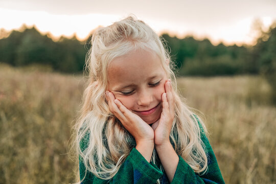 A carefree girl enjoys a serene moment in the countryside