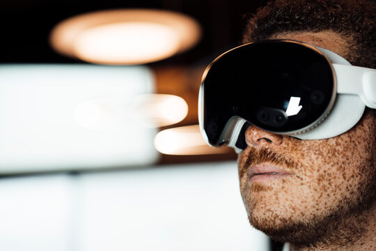 Freckled male wears vr glasses in the business office