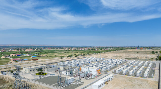Aerial View of a Large-Scale Battery Energy Storage Power Station Adjacent to Agricultural Land and Rural Settlements