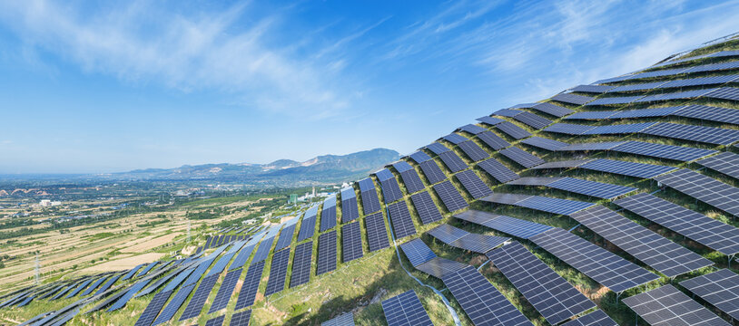 Large-Scale Solar Photovoltaic Plant Installed on Grassy Mountain Slopes with Valley View