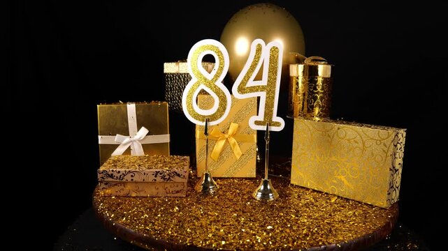 Gold Number 84 with Gold Glitter Confetti Sparkles with Gifts and Balloons for Party Eighty Four