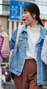 Laughing, people and walking with friends in city for social gathering, reunion or bonding together. Excited, holiday or group of happy students with smile for outing or memories in an urban town