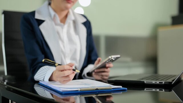 Women counting coins on calculator taking from the piggy bank. hand holding pen working on calculator to calculate on desk about cost at office.