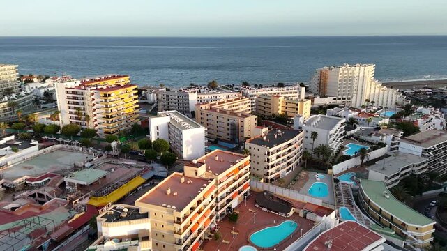 Aerial panorama flight over hotels in Playa del Ingles towards beach and Atlantic ocean in the evening on Canary Island Gran Canaria, Spain