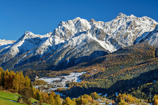 Snowcapped mountains with green trees on sunny day, Ardez, Lower Engadine, Engadine, Grisons, Switzerland