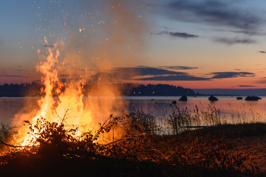 Large bonfire burning by the sea during the Venetian night festival in Ostrobothnia, Finland. Jakobstad, Pietarsaari